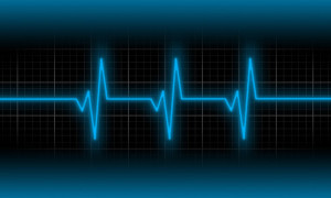 Electrocardiogram - Concept of healthcare heartbeat shown on monitor - blue