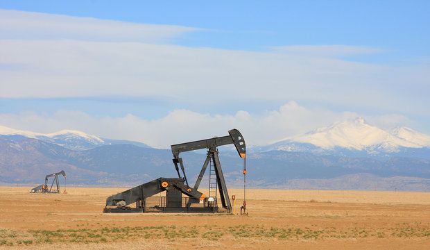 Pumpjack Pumping Oil, Snow Capped Mountain Background
