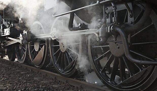 Steam locomotive rolling by close