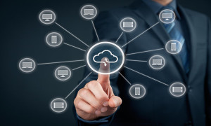 Cloud computing concept - connect IT devices (PC notebook tablet mobile phone) to cloud storage. Hand with cloud computing and computer icon.