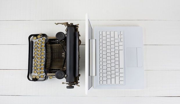 Overhead shot of and old fashioned typewriter back-to-back with