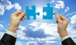 puzzle in hand isolated on sky background