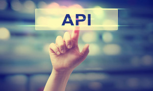 API concept with hand pressing a button on blurred abstract background