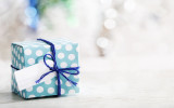 Small handmade gift box over shiny ornaments
