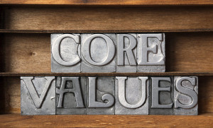 core values phrase made from metallic letterpress type on wooden tray