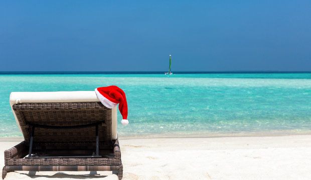 Sunbed with Christmas hat on a tropical beach