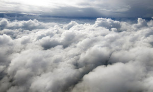Above the clouds in the sky. View from above the clouds. Flying over clouds in plane. Space boundless. Weather and climate. Big clouds. Atmosphere and stratosphere. Meteorology and aircraft.