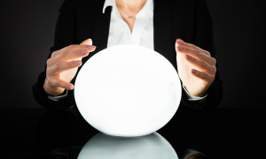 Businesswoman Hands On Crystal Ball On Black Background. Fortune Teller Predicting Future