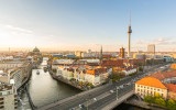 Berlin aerial view at sunset. Berlin Cathedral on the left tv tower on the right. Golden light over Berlin rooftops in the late afternoon. Travel and architecture concepts