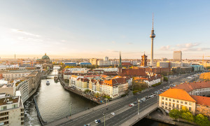 Berlin aerial view at sunset. Berlin Cathedral on the left tv tower on the right. Golden light over Berlin rooftops in the late afternoon. Travel and architecture concepts