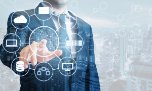 Double exposure of professional businessman connected devices with world digital technology internet and wireless network on touch screen and city of business background in business and technology concept