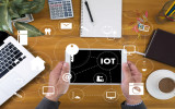 IOT business man hand working and internet of things (IoT) word diagram as concept