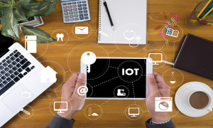 IOT business man hand working and internet of things (IoT) word diagram as concept