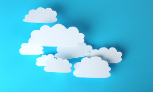White paper clouds on blue background. Cloud computing concept.