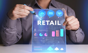 Business Technology Internet and network concept. Young businessman working on a virtual screen of the future and sees the inscription: Retail