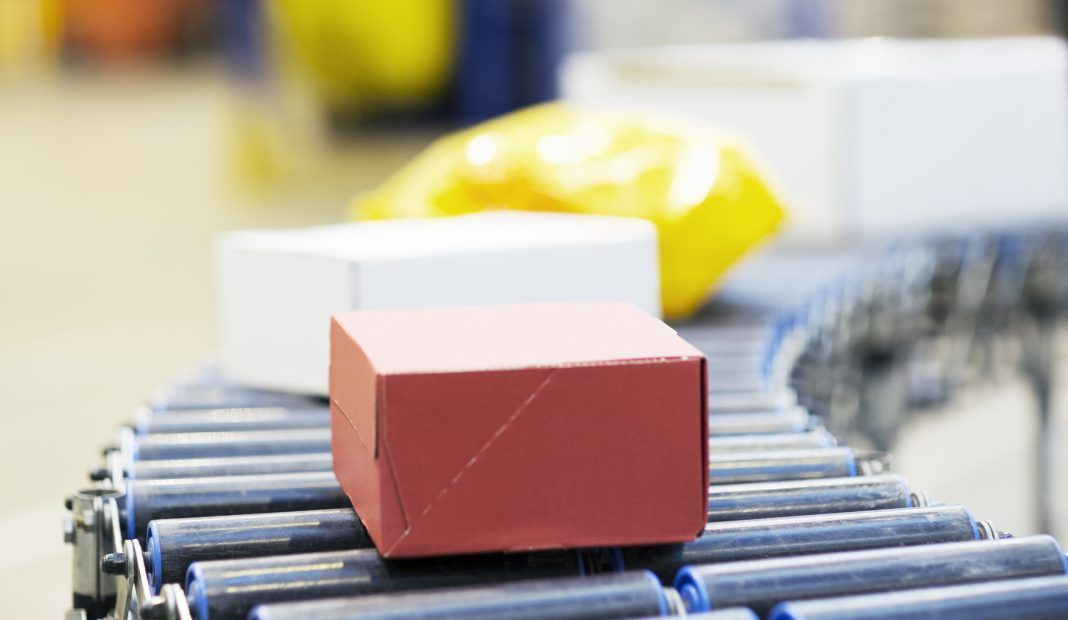 Packages on conveyor belt in warehouse