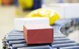 Packages on conveyor belt in warehouse