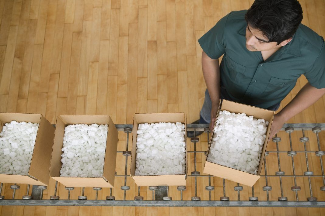Man carrying a box full of styrofoam