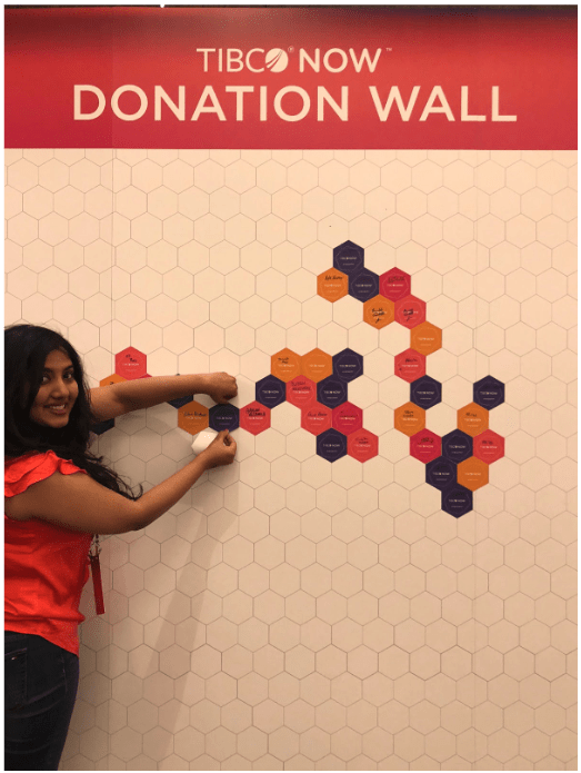A conference participant adds her name to the Donation Wall at TIBCO NOW