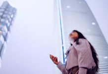 woman holding phone in city