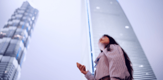 woman holding phone in city