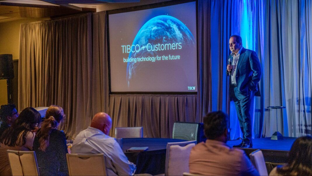 image7 A man in a suit delivers a presentation at a conference, engaging the audience with his insights and expertise.