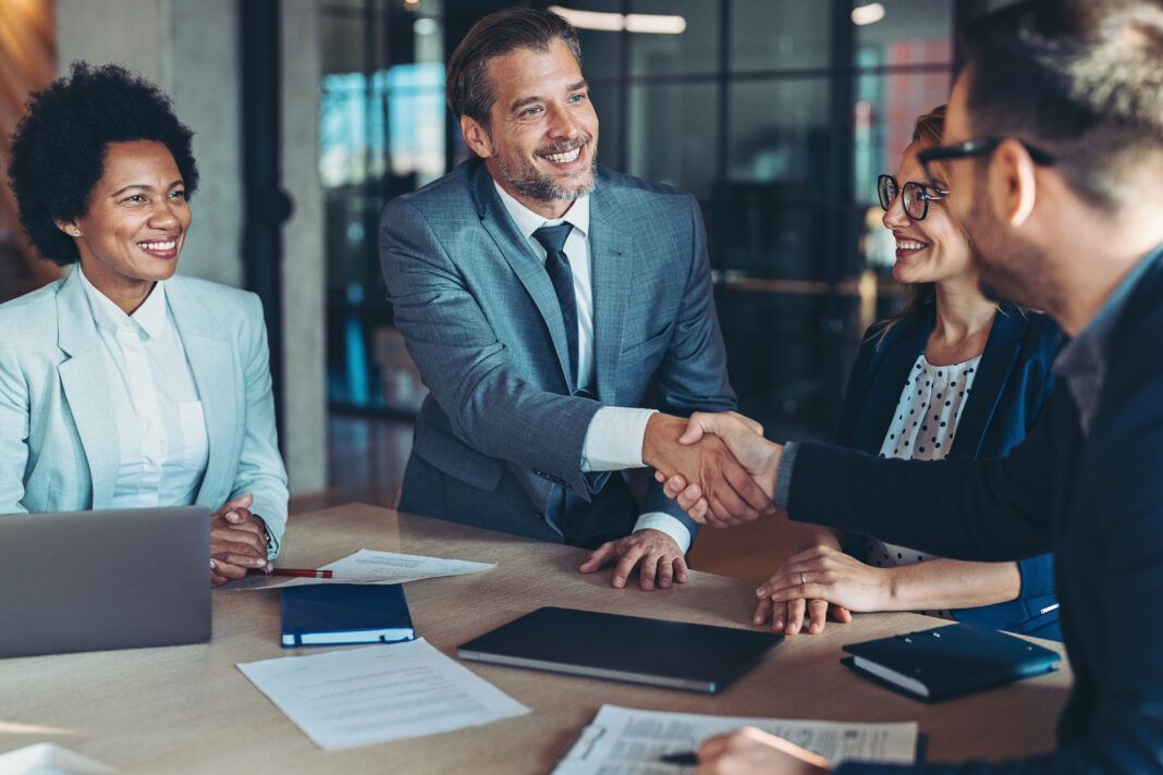 Businessmen shaking hands across the table Partner Onboarding