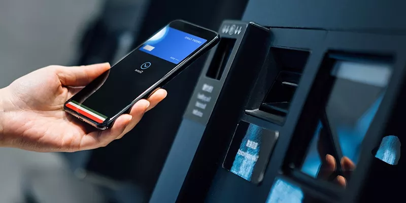 Bridge gaps between teams Person using a smartphone for contactless payment at a vending machine.