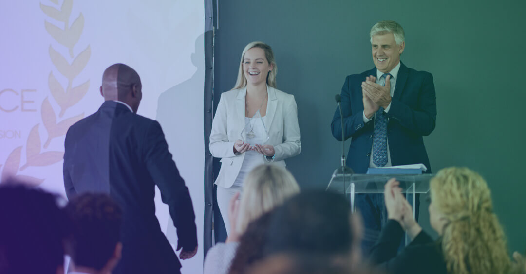 Applause as a speaker walks to the front of the room in an office setting