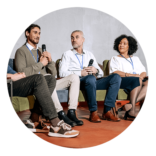 Three professionals sitting in a row during a panel discussion