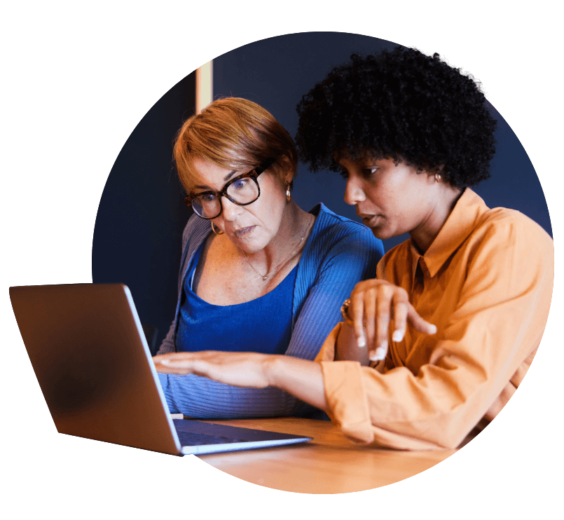 Two woman looking at laptop