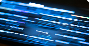 Blurred motion of blue and white light streaks on a dark background